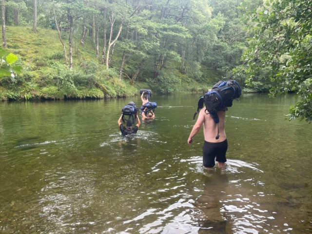 Wading through a river in the Lake District